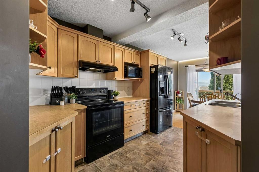 10-117 Bow Ridge Drive, Cochrane, AB - Indoor Photo Showing Kitchen With Double Sink