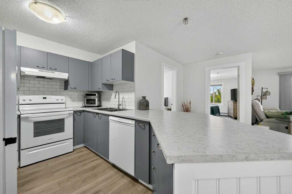 2207-12 Cimarron Common, Okotoks, AB - Indoor Photo Showing Kitchen With Double Sink