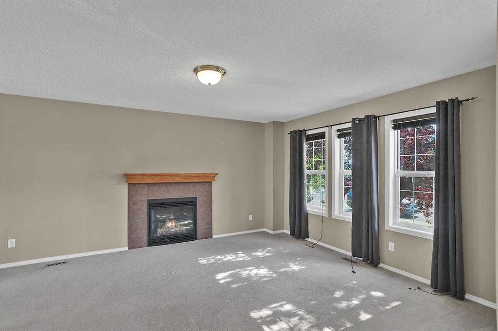 706 Everridge Drive Sw, Calgary, AB - Indoor Photo Showing Living Room With Fireplace