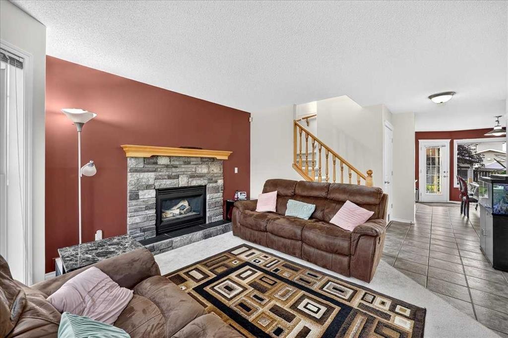 155 Tarington Green Ne, Calgary, AB - Indoor Photo Showing Living Room With Fireplace