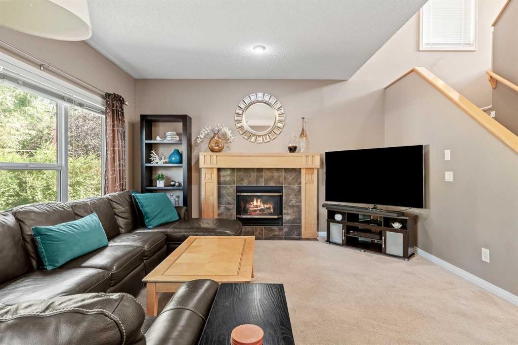 52 Copperfield Close Se, Calgary, AB - Indoor Photo Showing Living Room With Fireplace
