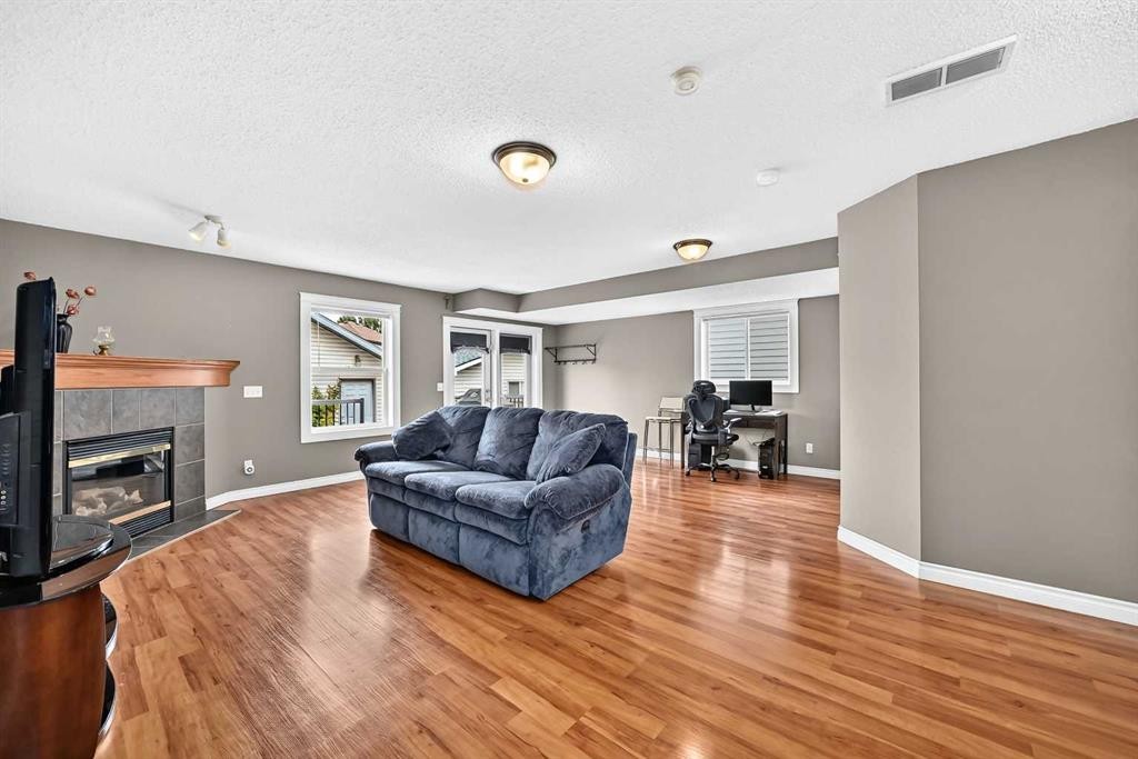 27 Erin Meadow Crescent Se, Calgary, AB - Indoor Photo Showing Living Room With Fireplace