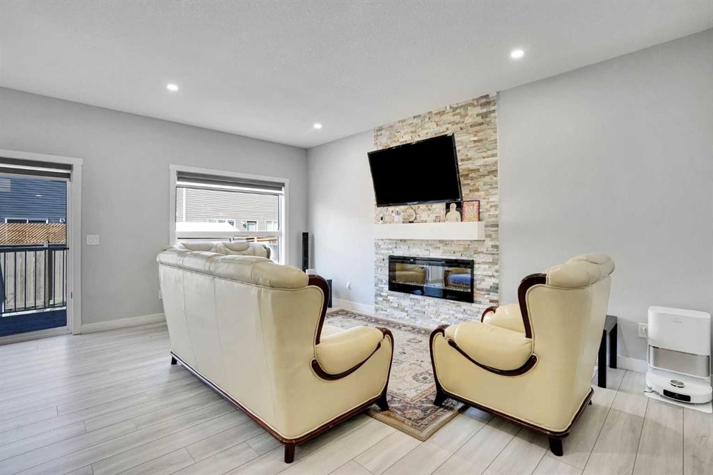 50 Saddlestone Place Ne, Calgary, AB - Indoor Photo Showing Other Room With Fireplace