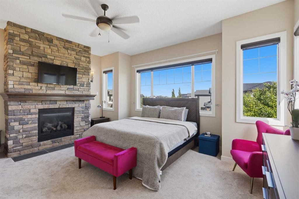82 Brightonwoods Green Se, Calgary, AB - Indoor Photo Showing Bedroom With Fireplace