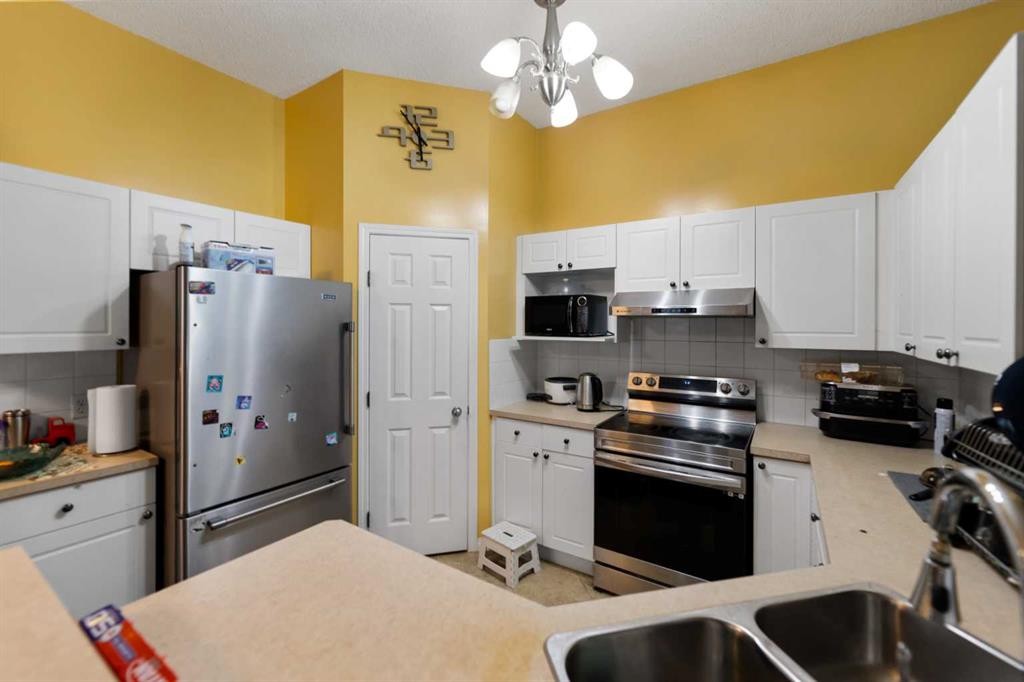 5036 Martin Crossing Drive Ne, Calgary, AB - Indoor Photo Showing Kitchen With Stainless Steel Kitchen With Double Sink