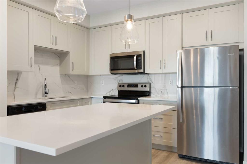 202-150 Shawnee Square Sw, Calgary, AB - Indoor Photo Showing Kitchen With Stainless Steel Kitchen With Upgraded Kitchen
