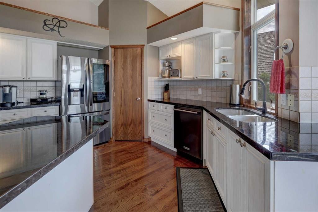 321 Gleneagles View, Cochrane, AB - Indoor Photo Showing Kitchen With Double Sink