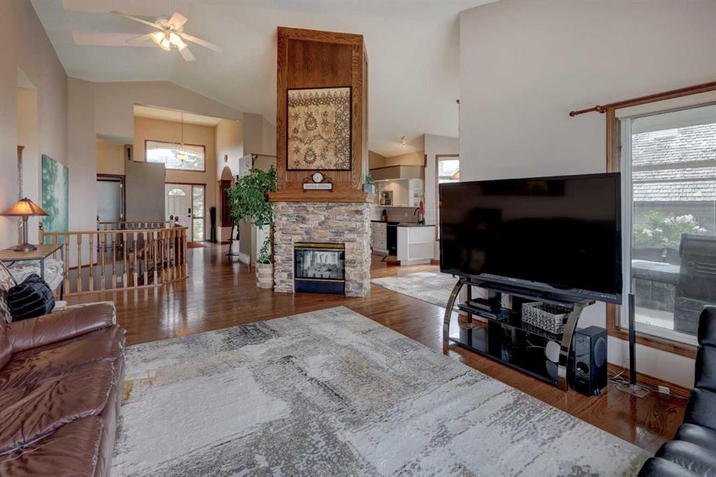 321 Gleneagles View, Cochrane, AB - Indoor Photo Showing Living Room With Fireplace