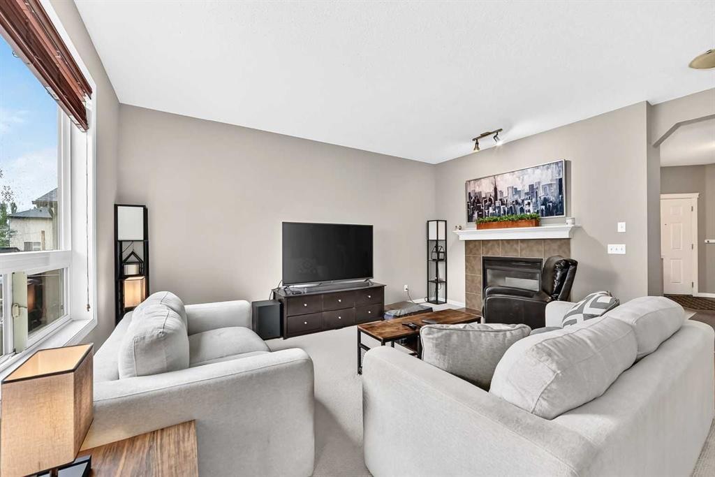 121 Chapalina Heights Se, Calgary, AB - Indoor Photo Showing Living Room With Fireplace