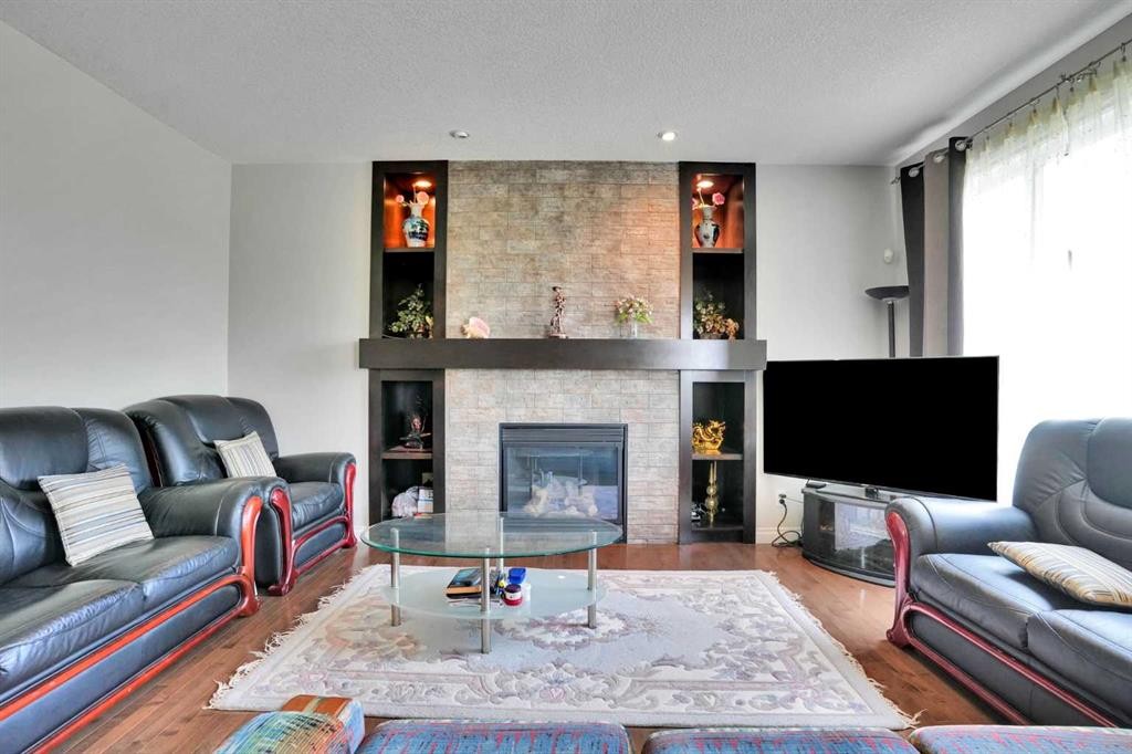 126 Panatella Crescent Nw, Calgary, AB - Indoor Photo Showing Living Room With Fireplace
