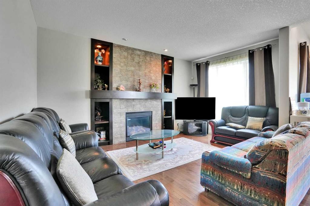 126 Panatella Crescent Nw, Calgary, AB - Indoor Photo Showing Living Room With Fireplace
