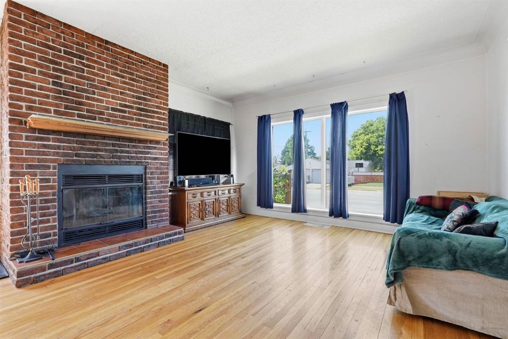 2037 18 Avenue, Didsbury, AB - Indoor Photo Showing Living Room With Fireplace
