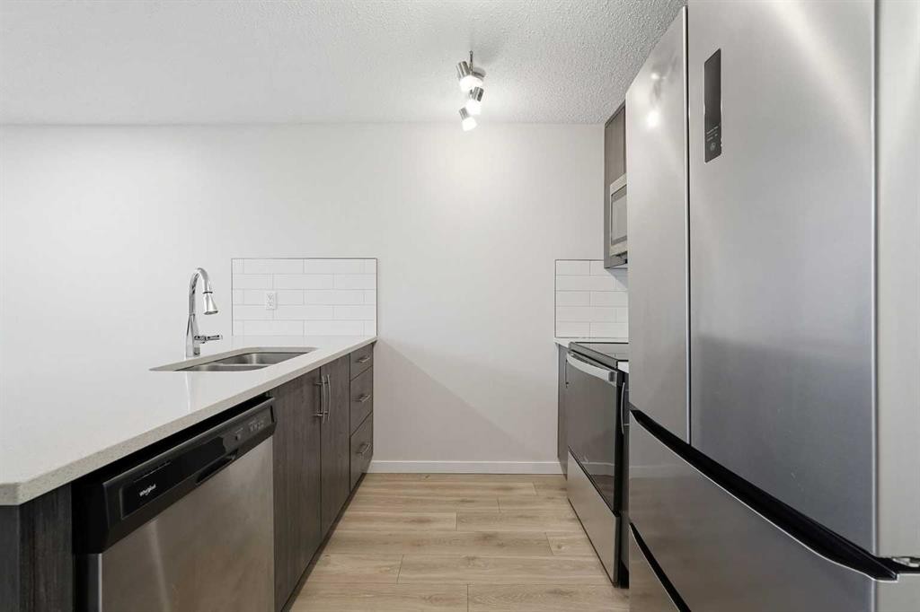 124 Cranbrook Square Se, Calgary, AB - Indoor Photo Showing Kitchen With Stainless Steel Kitchen With Double Sink