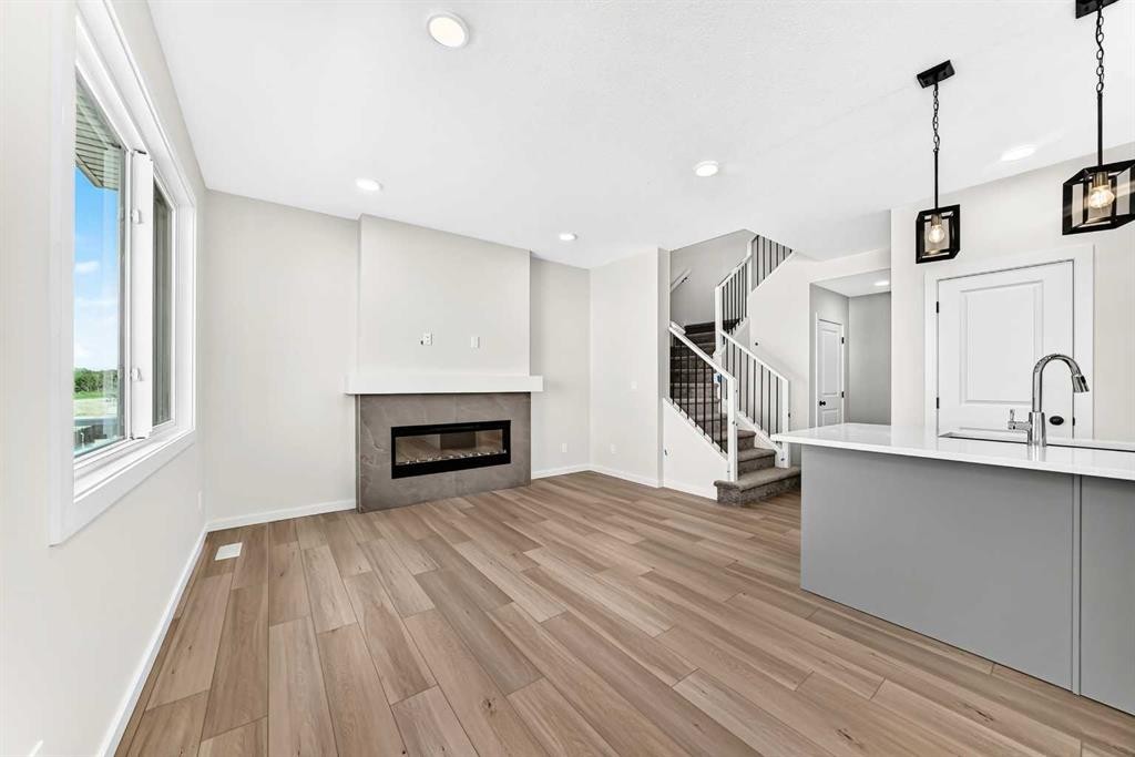 135 Mallard Heath Se, Calgary, AB - Indoor Photo Showing Other Room With Fireplace