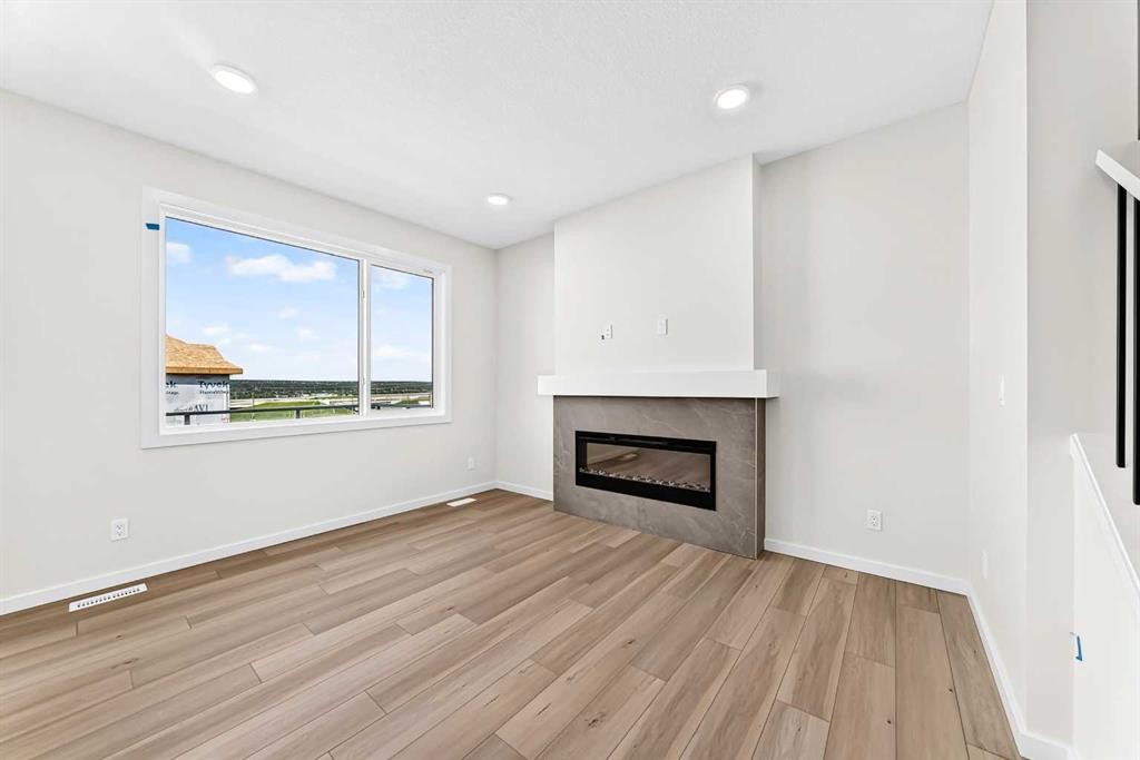 135 Mallard Heath Se, Calgary, AB - Indoor Photo Showing Living Room With Fireplace
