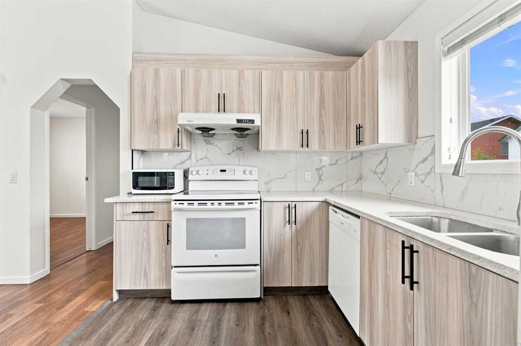 11 Martin Crossing Rise Ne, Calgary, AB - Indoor Photo Showing Kitchen With Double Sink