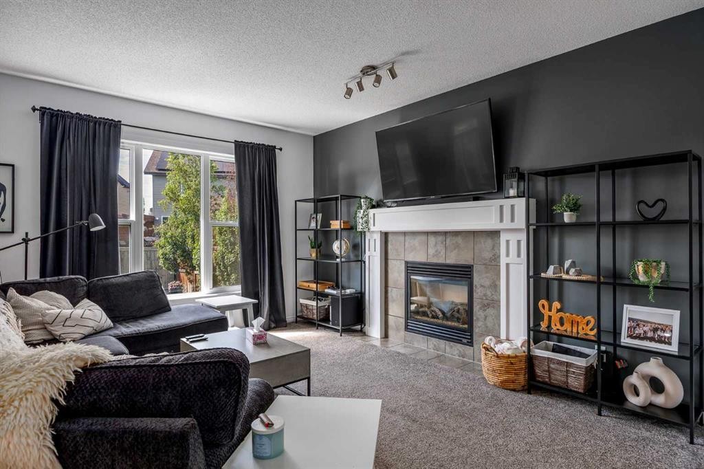 5 Copperpond Link Se, Calgary, AB - Indoor Photo Showing Living Room With Fireplace