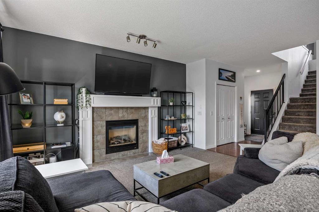 5 Copperpond Link Se, Calgary, AB - Indoor Photo Showing Living Room With Fireplace