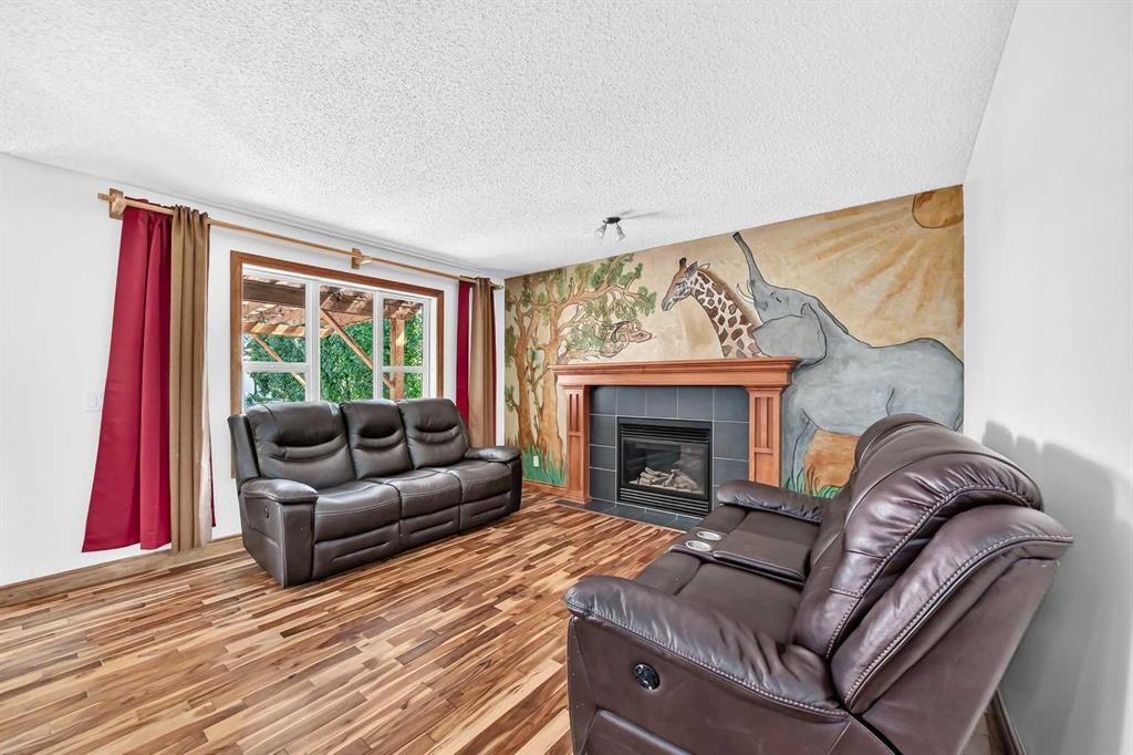 988 Copperfield Boulevard Se, Calgary, AB - Indoor Photo Showing Living Room With Fireplace