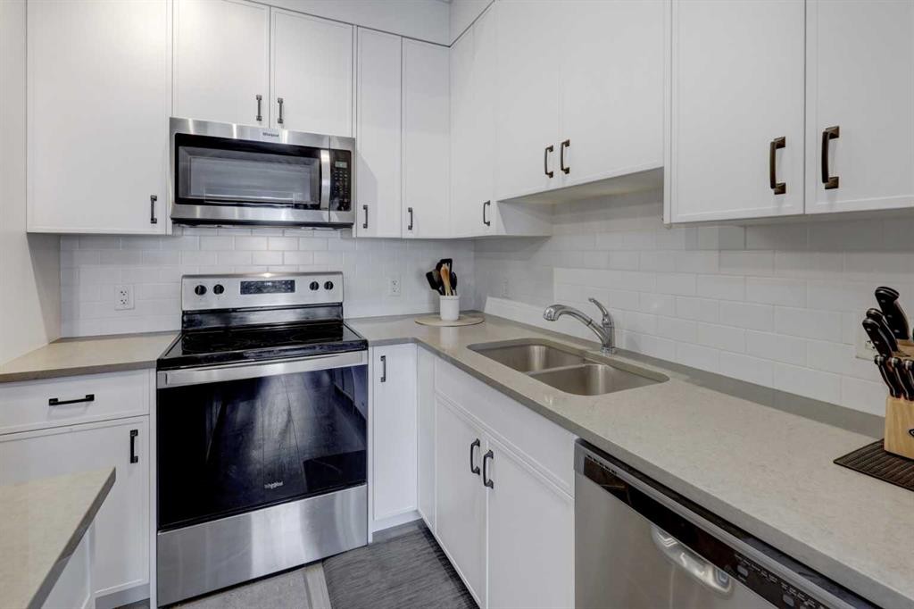 214 Livingston Common Ne, Calgary, AB - Indoor Photo Showing Kitchen With Stainless Steel Kitchen With Double Sink