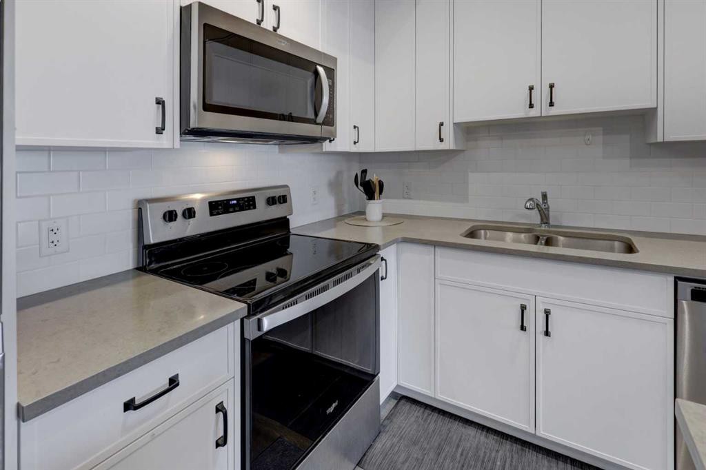214 Livingston Common Ne, Calgary, AB - Indoor Photo Showing Kitchen With Stainless Steel Kitchen With Double Sink