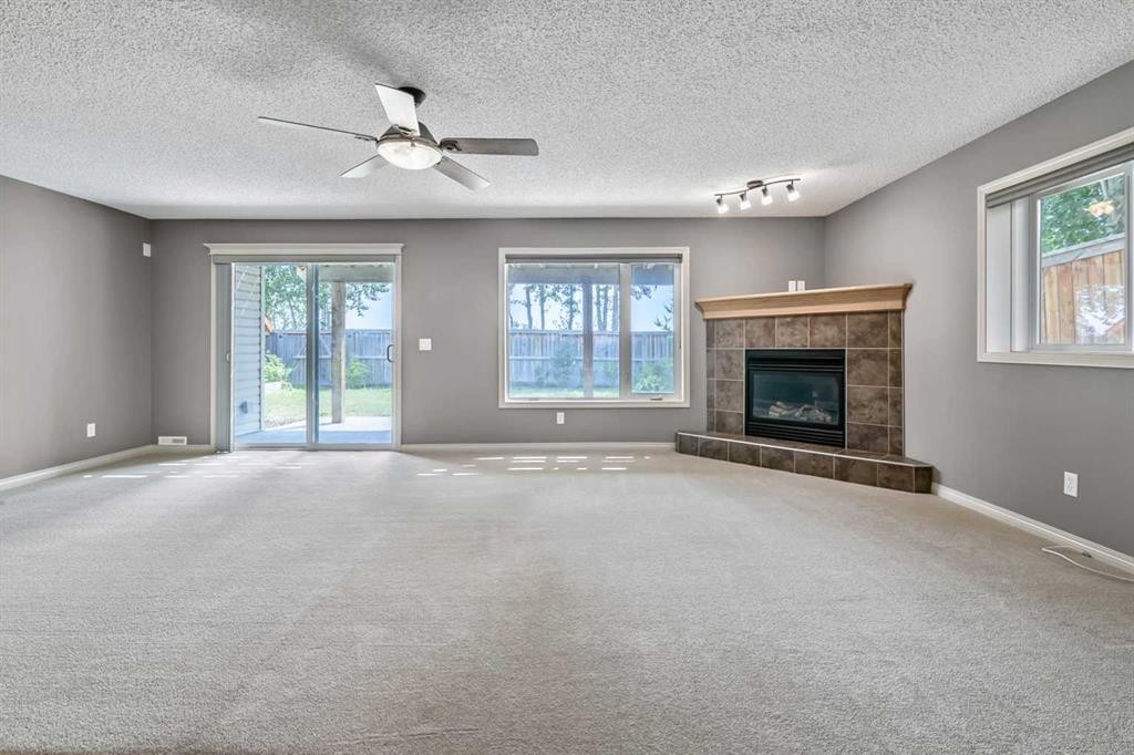315 Willow Ridge Way, Diamond Valley, AB - Indoor Photo Showing Living Room With Fireplace