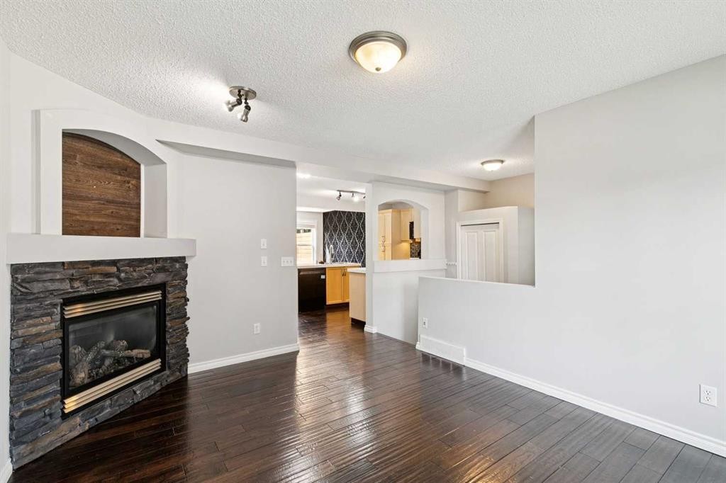 208 Everridge Way Sw, Calgary, AB - Indoor Photo Showing Living Room With Fireplace