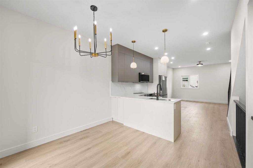 301-67 Panatella Square Nw, Calgary, AB - Indoor Photo Showing Kitchen With Double Sink