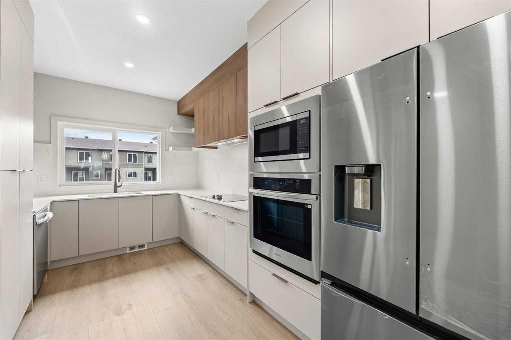 302-67 Panatella Square Nw, Calgary, AB - Indoor Photo Showing Kitchen With Stainless Steel Kitchen With Upgraded Kitchen