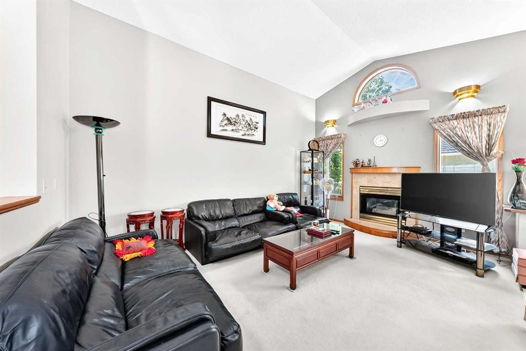 184 Hampshire Circle Nw, Calgary, AB - Indoor Photo Showing Living Room With Fireplace