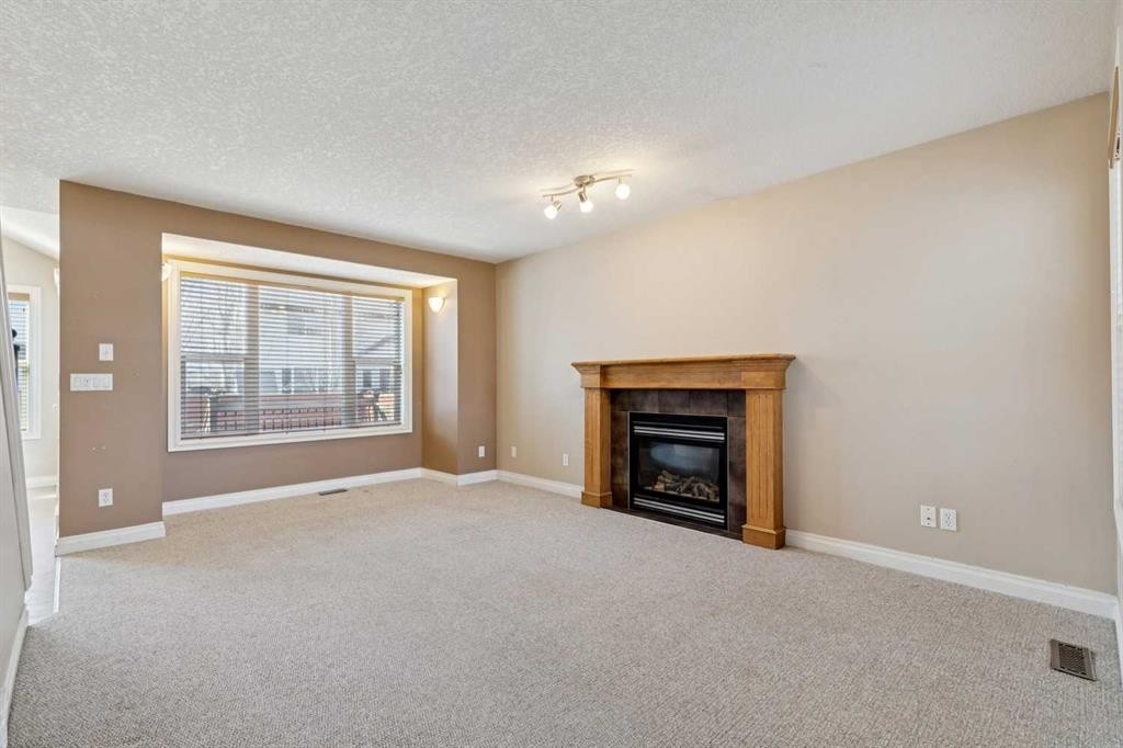 184 Cimarron Park Circle, Okotoks, AB - Indoor Photo Showing Living Room With Fireplace