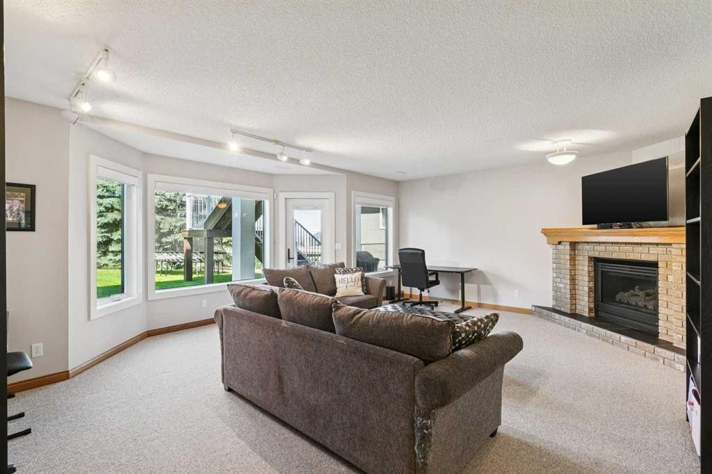 22 Patrick View Sw, Calgary, AB - Indoor Photo Showing Living Room With Fireplace