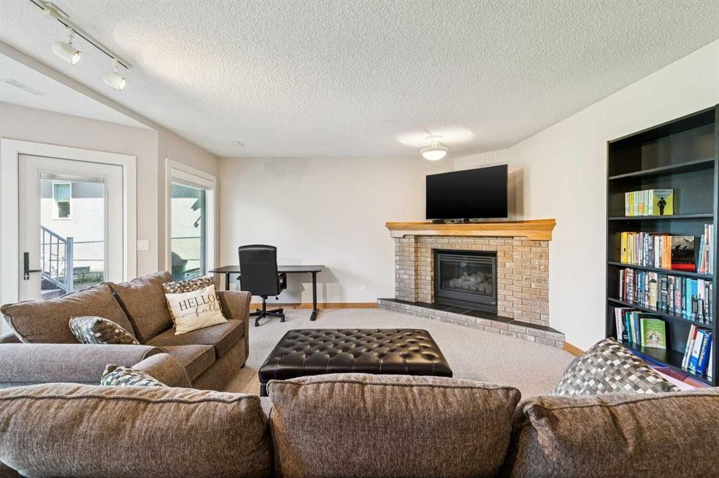 22 Patrick View Sw, Calgary, AB - Indoor Photo Showing Living Room With Fireplace