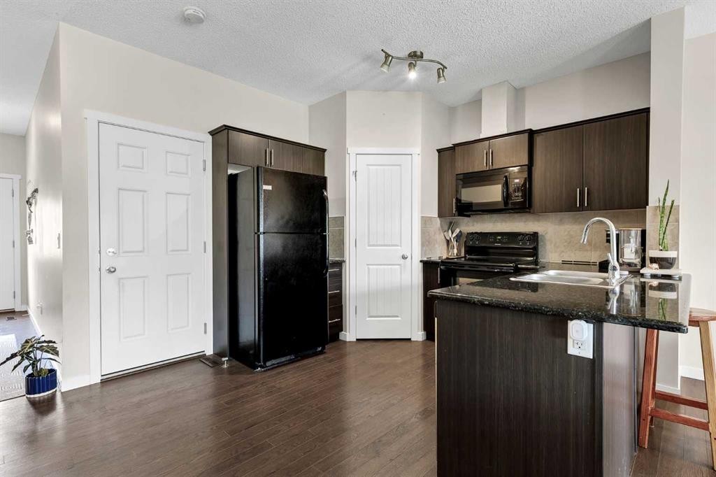 72 Copperpond Landing Se, Calgary, AB - Indoor Photo Showing Kitchen With Double Sink