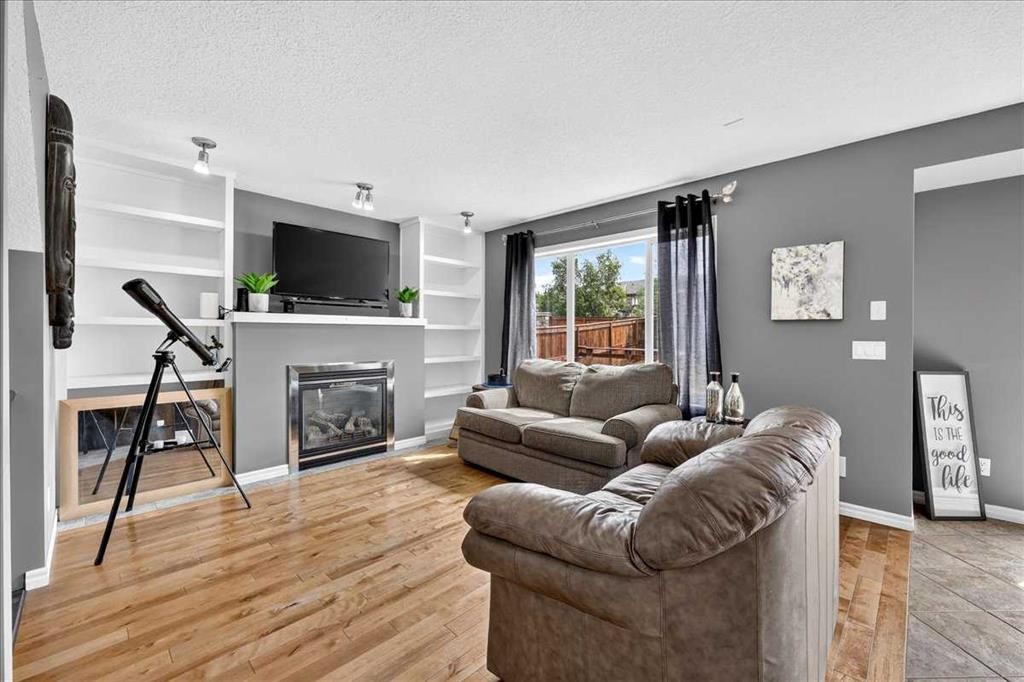 128 Cranberry Circle Se, Calgary, AB - Indoor Photo Showing Living Room With Fireplace