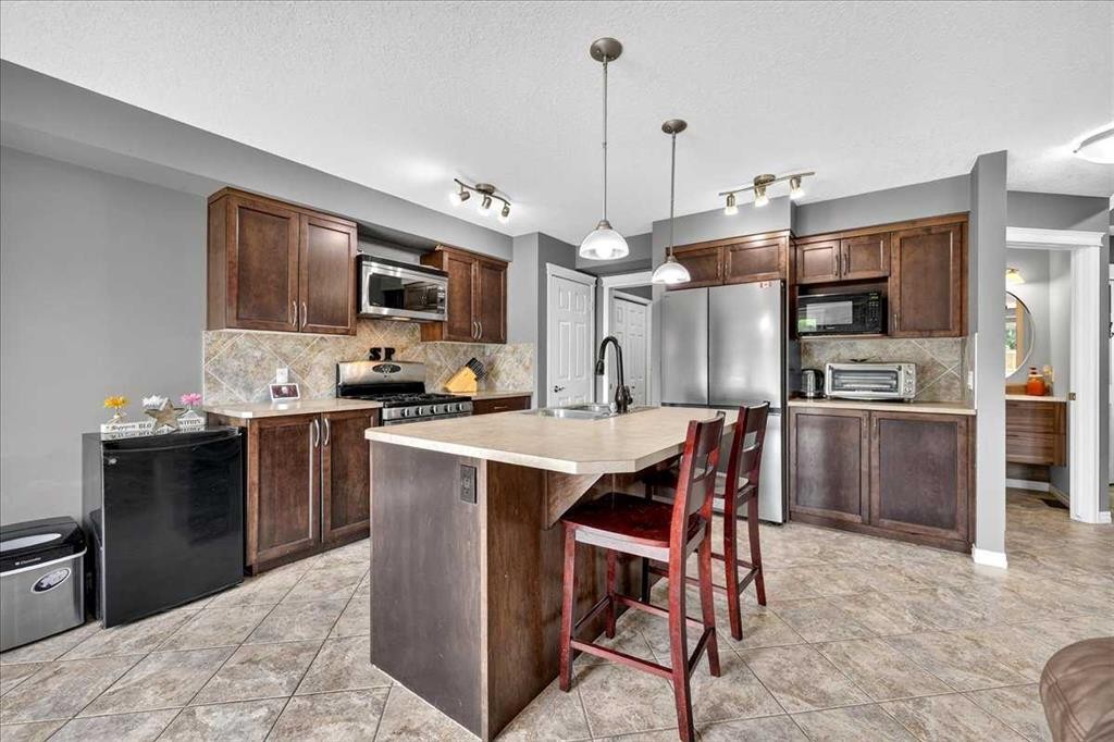 128 Cranberry Circle Se, Calgary, AB - Indoor Photo Showing Kitchen With Stainless Steel Kitchen