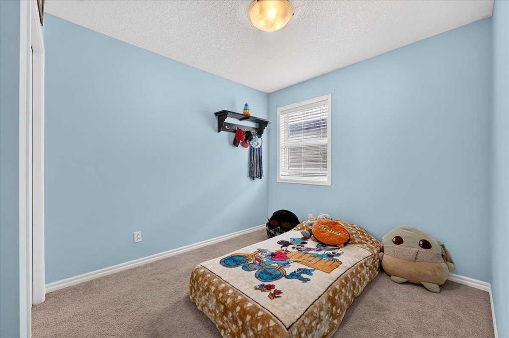 128 Cranberry Circle Se, Calgary, AB - Indoor Photo Showing Bedroom