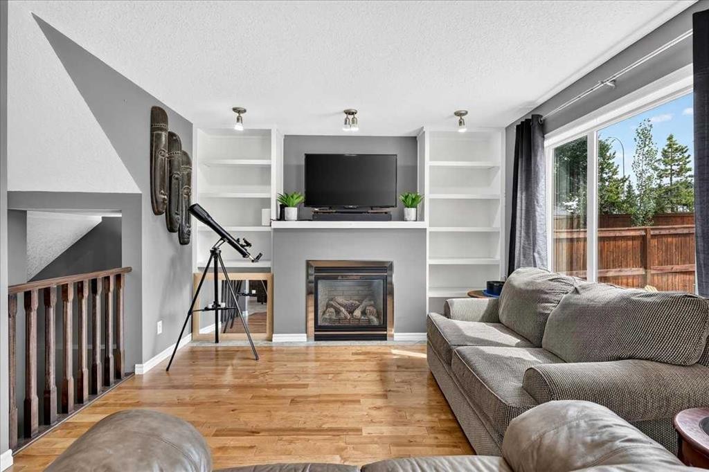 128 Cranberry Circle Se, Calgary, AB - Indoor Photo Showing Living Room With Fireplace