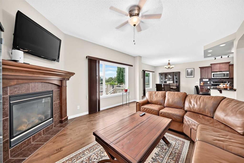 212 Aspenmere Close, Chestermere, AB - Indoor Photo Showing Living Room With Fireplace