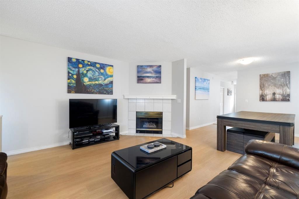76 Douglas Ridge Close Se, Calgary, AB - Indoor Photo Showing Living Room With Fireplace