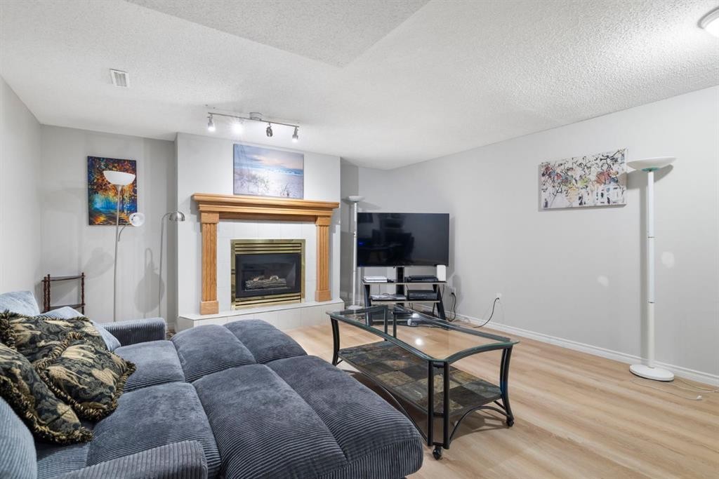 76 Douglas Ridge Close Se, Calgary, AB - Indoor Photo Showing Living Room With Fireplace