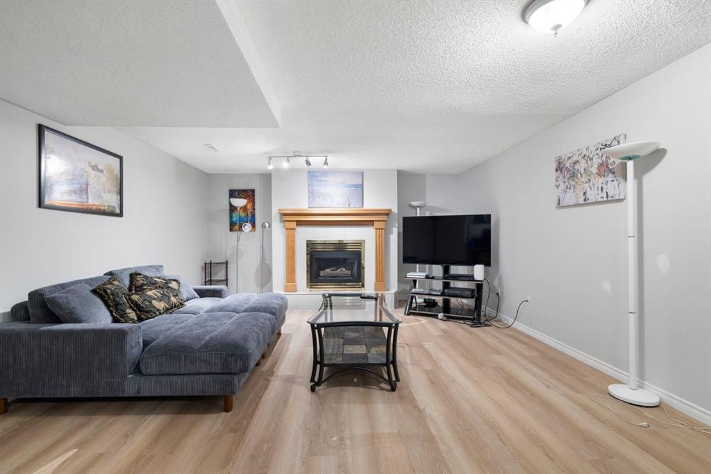 76 Douglas Ridge Close Se, Calgary, AB - Indoor Photo Showing Living Room With Fireplace