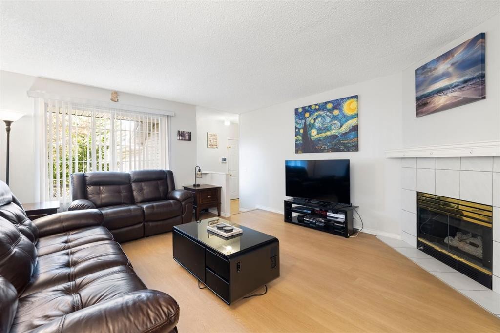 76 Douglas Ridge Close Se, Calgary, AB - Indoor Photo Showing Living Room With Fireplace