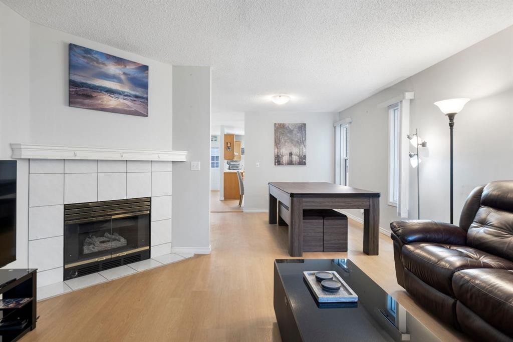 76 Douglas Ridge Close Se, Calgary, AB - Indoor Photo Showing Living Room With Fireplace