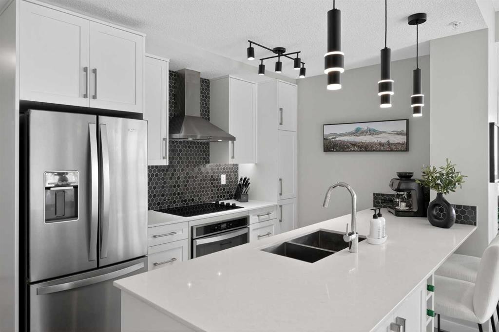 302-2231 Mahogany Boulevard Se, Calgary, AB - Indoor Photo Showing Kitchen With Double Sink With Upgraded Kitchen