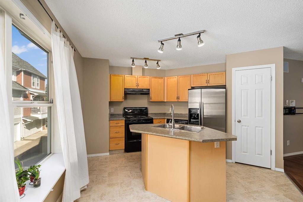 205 Mckenzie Towne Gate Se, Calgary, AB - Indoor Photo Showing Kitchen With Double Sink