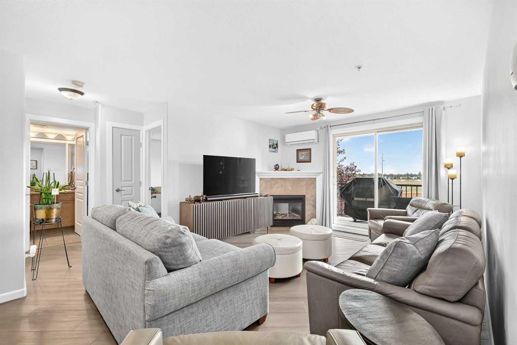 208-30 Cranfield Link Se, Calgary, AB - Indoor Photo Showing Living Room With Fireplace
