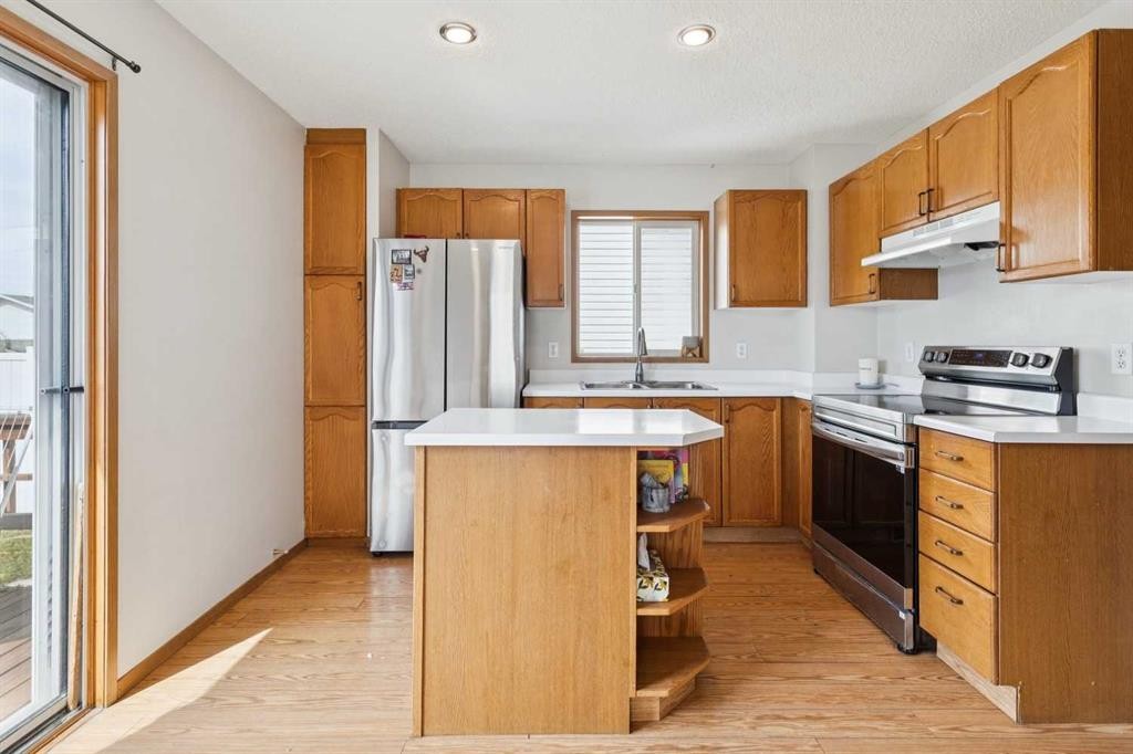 151 Rivercrest Close Se, Calgary, AB - Indoor Photo Showing Kitchen With Double Sink