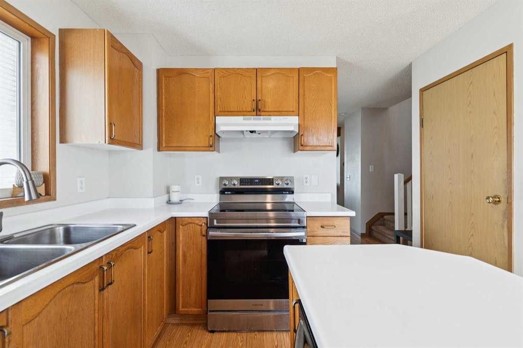 151 Rivercrest Close Se, Calgary, AB - Indoor Photo Showing Kitchen With Double Sink