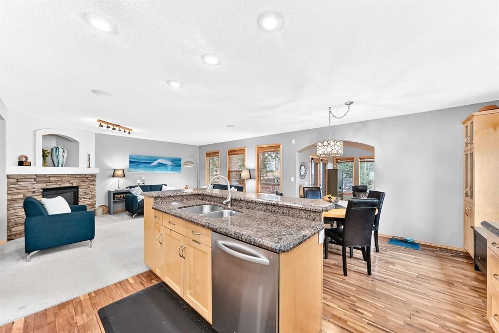 206 Panamount Grove Nw, Calgary, AB - Indoor Photo Showing Kitchen With Fireplace With Double Sink